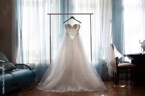 The perfect wedding dress with a full skirt on a hanger Fototapet