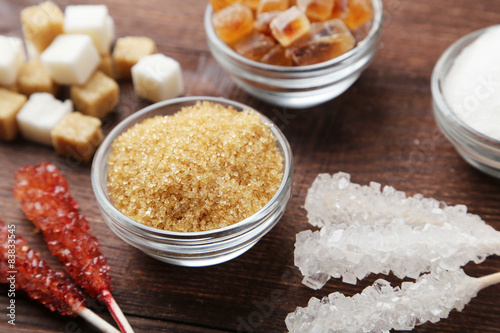 Various kinds of sugar on wooden background