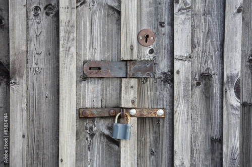 Fragment of wooden door with a key lock.
