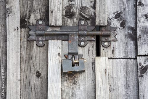 Fragment of wooden door with a key lock.
