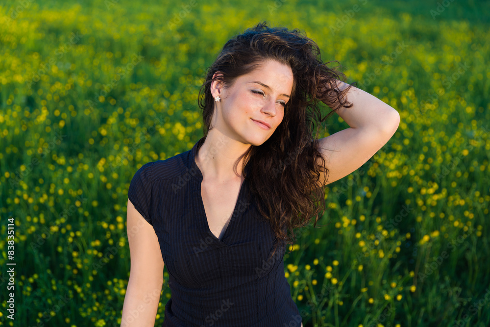 Young beautiful woman with hand in her hair enjoying sunset. Young beautiful woman with hand in her hair enjoying sunset.