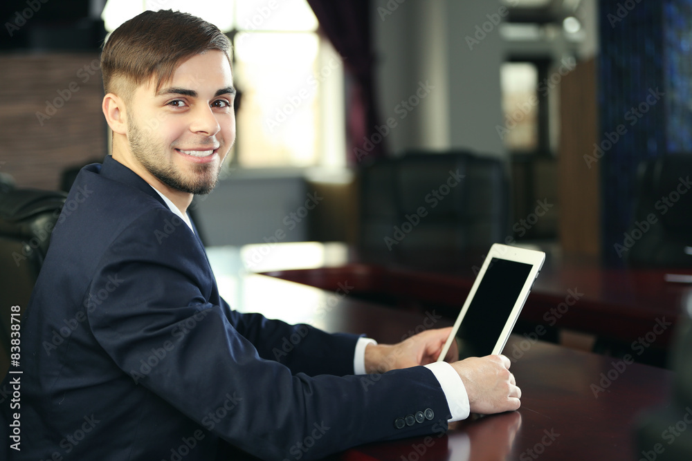 Businessman working with tablet in office Businessman working with tablet in office
