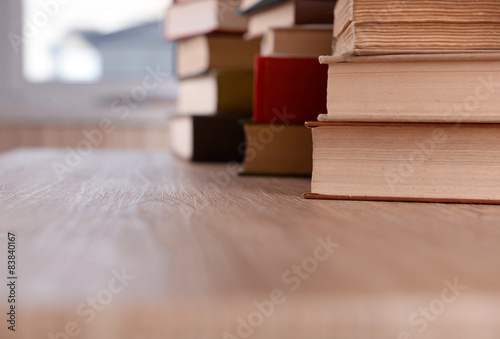 Stacks of books on table close up