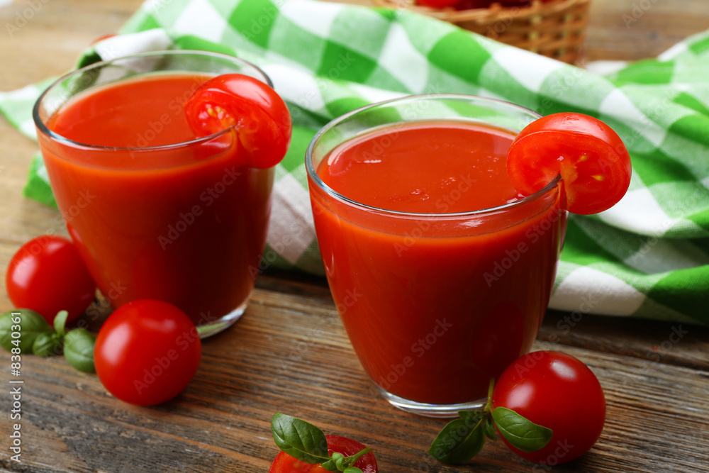 Glasses of tomato juice with vegetables on table close up Glasses of tomato juice with vegetables on table close up