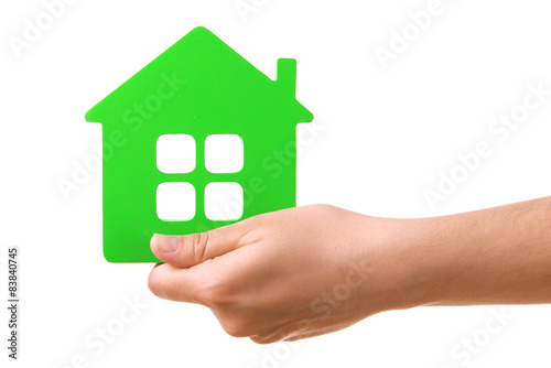 Female hand with small model of house isolated on white