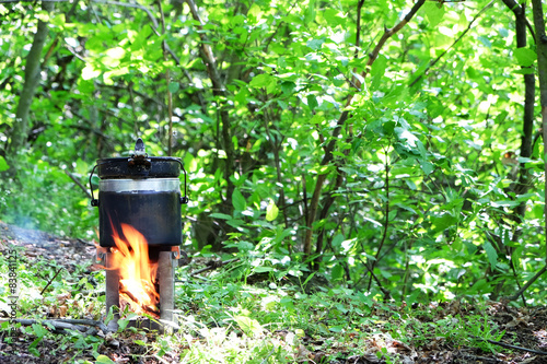 Tourist kettle above fire in park