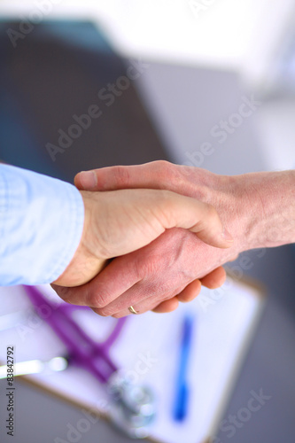 Doctor shakes hands with a patient  © lenetsnikolai