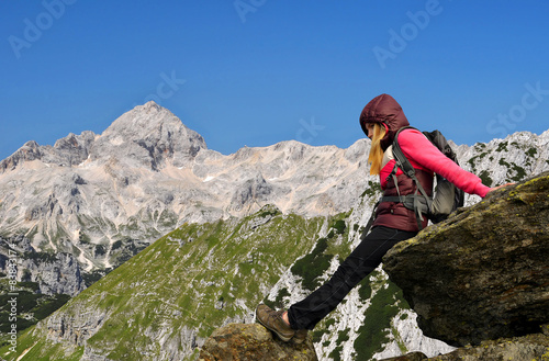 Girl on rock, in the background mount Triglav - Slovenia