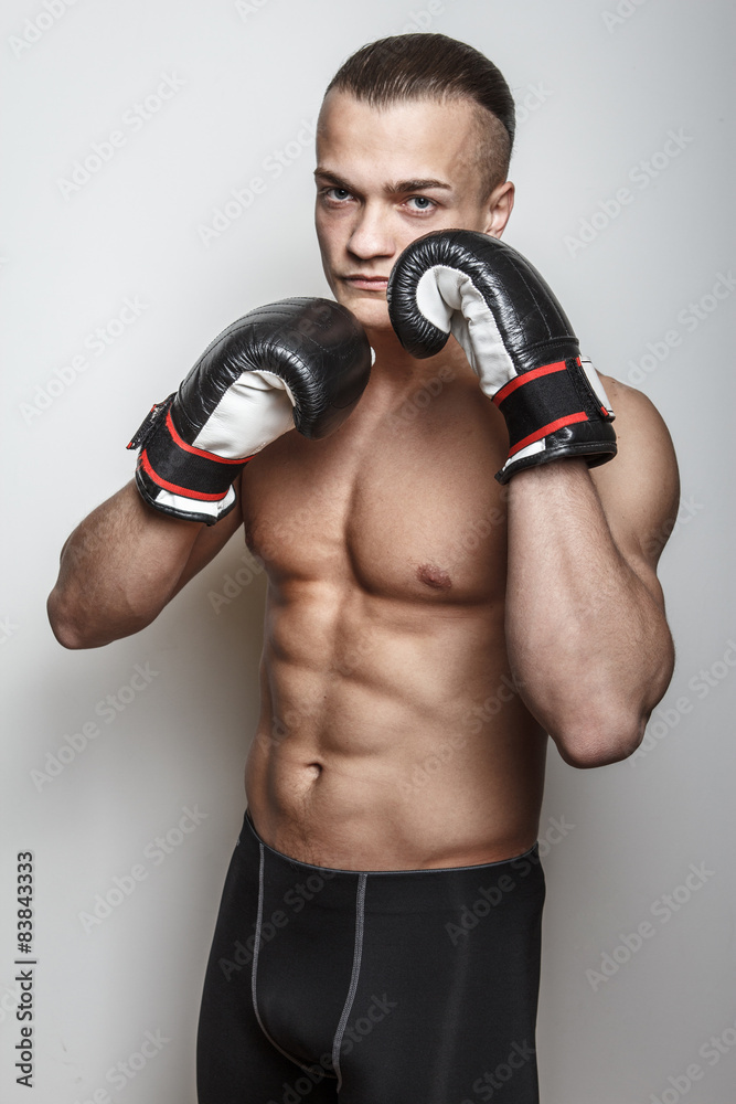Muscular guy in boxing gloves