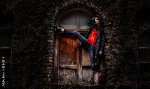 Casula girl posing over old window