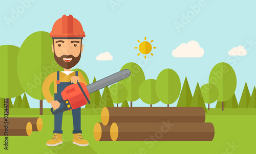 Lumberjack cuts a tree by chainsaw