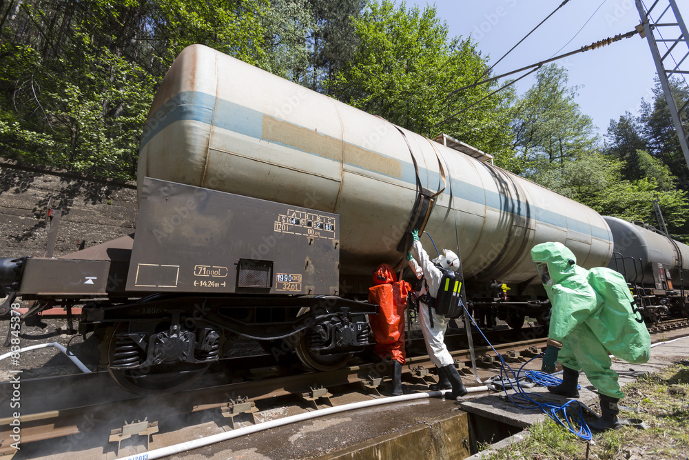 Fototapeta premium Toxic chemicals acids emergency team near train