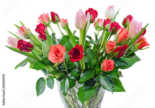 Red Roses flowers with pink tulips, transparent vase.