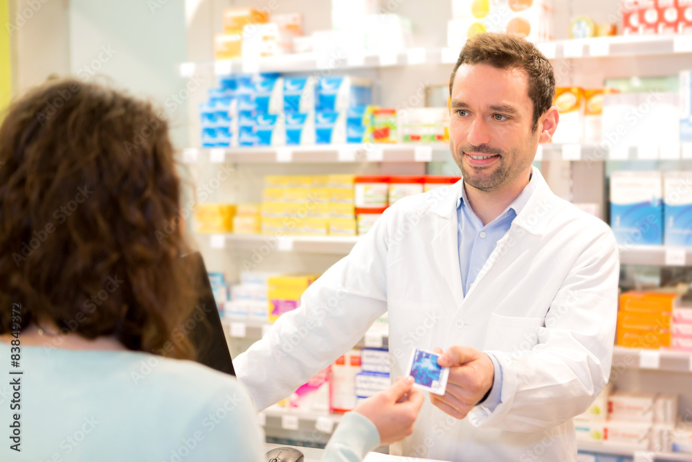 Attractive pharmacist taking healt credit card Attractive pharmacist taking healt credit card