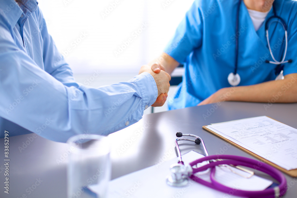 Doctor shakes hands with a patient Doctor shakes hands with a patient