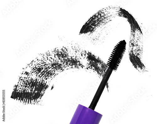Mascara applicator with a smudge in the background