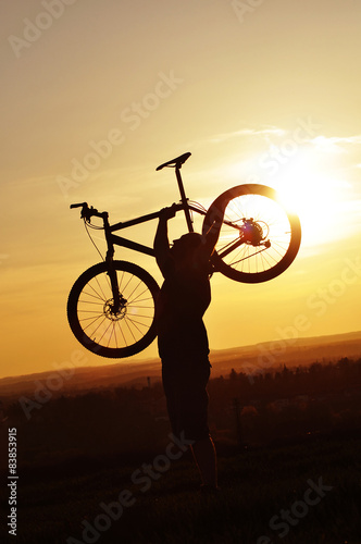 Man raising up his bicycle