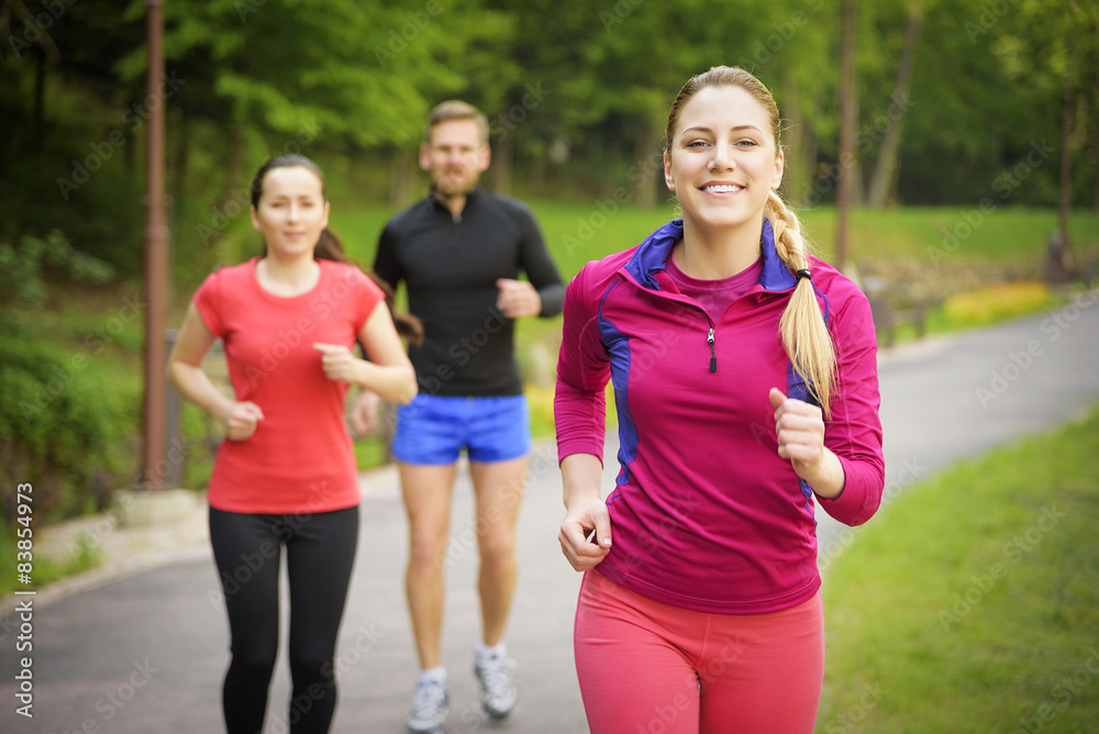 Fototapeta premium Smiling friends running outdoors.