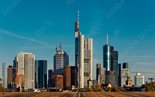 background with wooden deck table and Skyline in Frankfurt