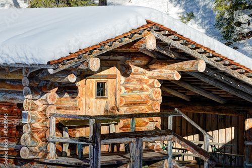 Winter holiday house in rising sun beams in the Alps in winter photo