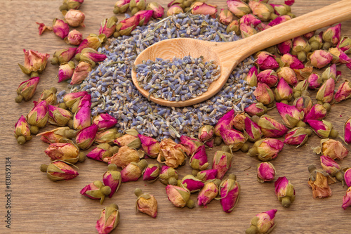 Dried lavender and rose flower tea in wooden spoon