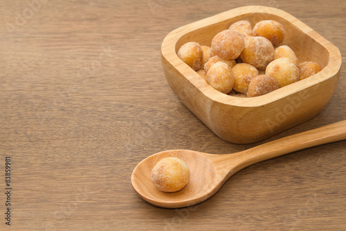 macadamia nuts in a wooden spoon