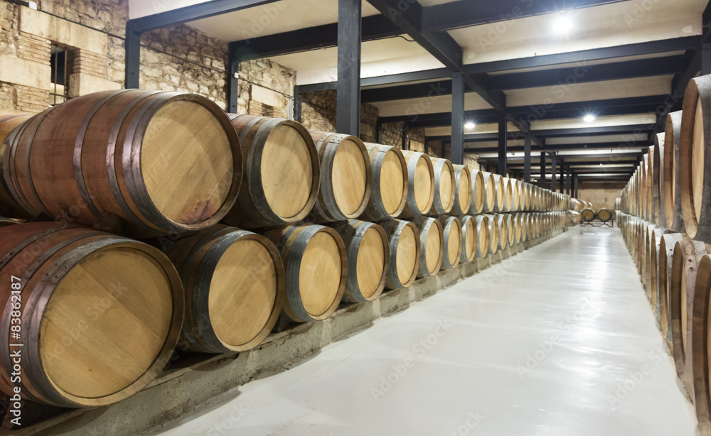 barrels in rows at  wine factory