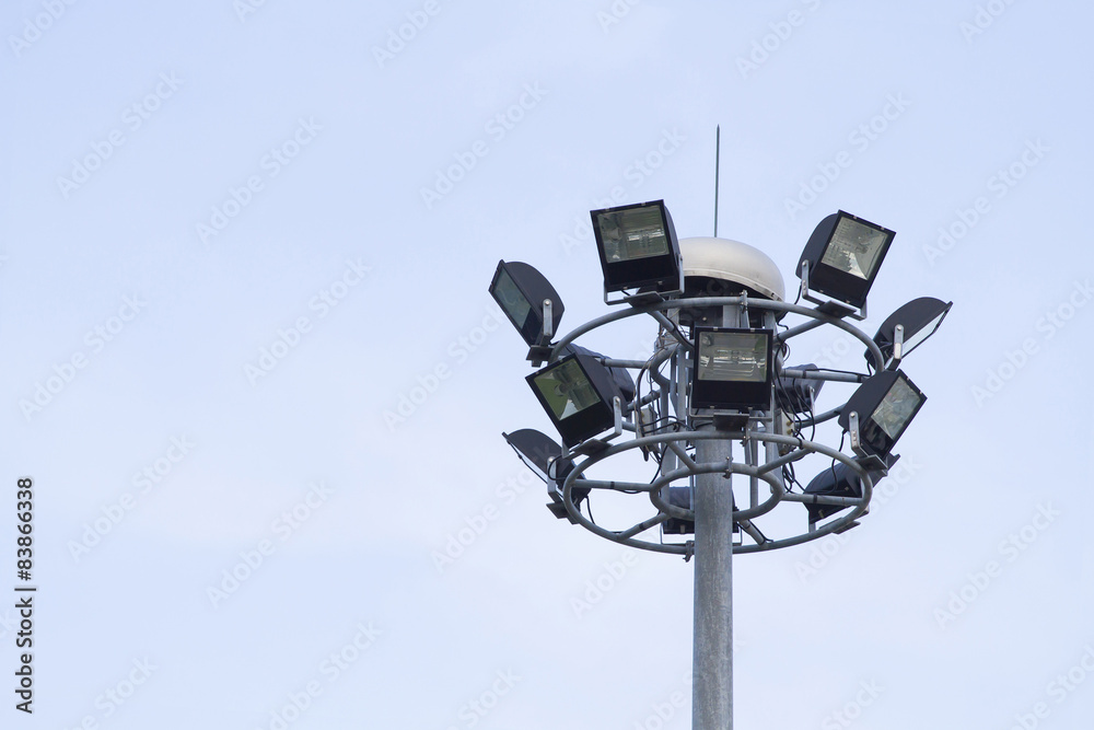 Big spotlight pole on blue sky background Big spotlight pole on blue sky background