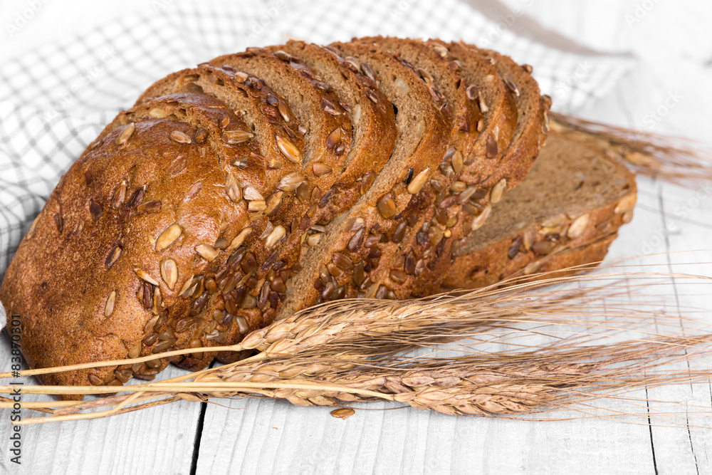 Sliced bread with sunflower seeds and ears of wheat