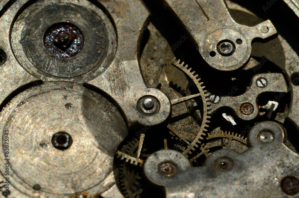 Closeup of cogweels in clockwork, grunge background for steampun