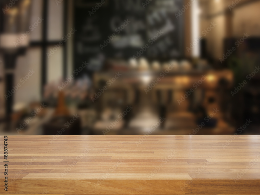 mpty wooden table and blurred cafe background