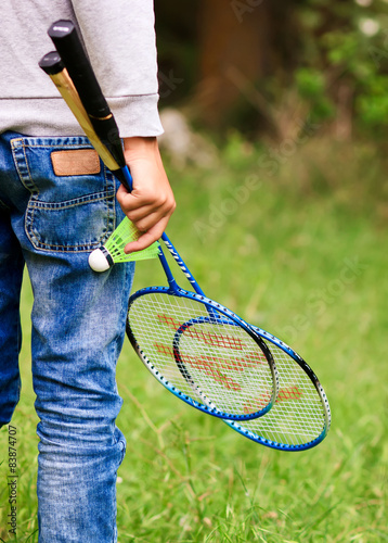 Niño con raquetas y pluma de badminton