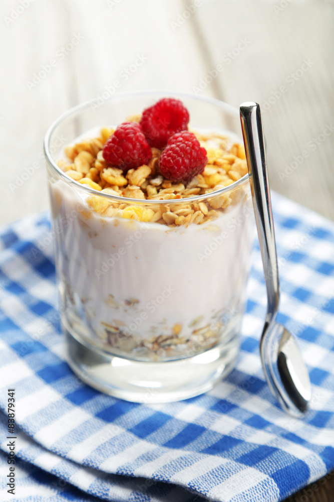 Muesli with yogurt and raspberries in a glass Muesli with yogurt and raspberries in a glass