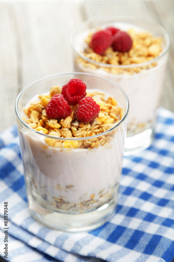 Muesli with yogurt and raspberries in a glass Muesli with yogurt and raspberries in a glass