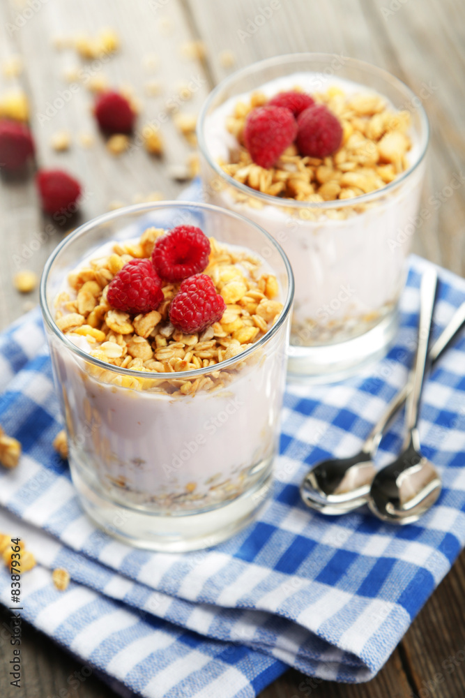 Muesli with yogurt and raspberries in a glass Muesli with yogurt and raspberries in a glass
