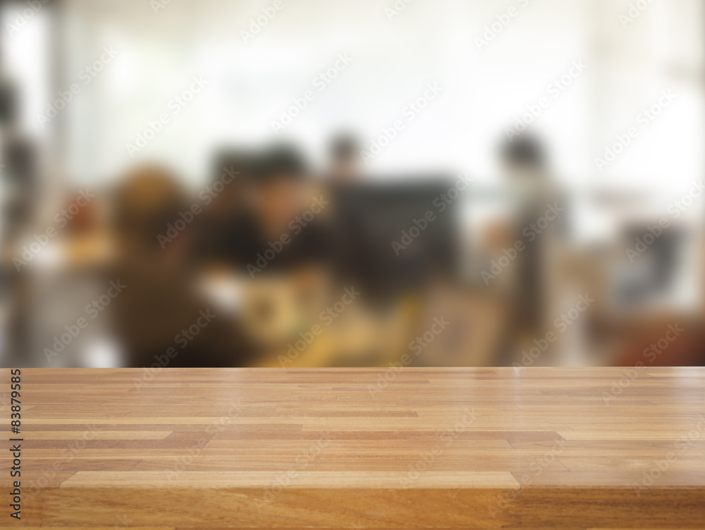 Empty wooden table and blurred business people background Empty wooden table and blurred business people background