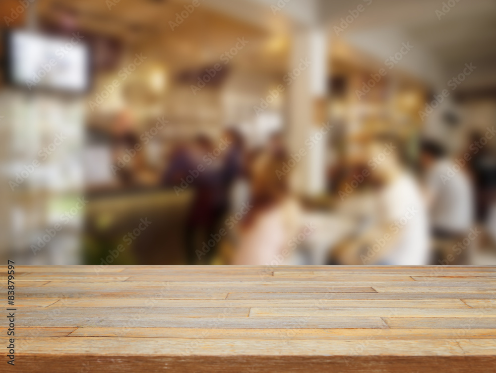 Empty wooden table and blurred people in cafe background Empty wooden table and blurred people in cafe background