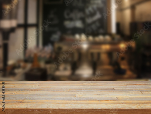 mpty wooden table and blurred cafe background