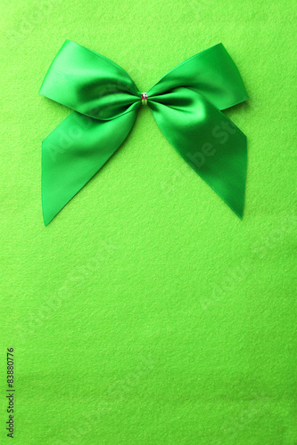 Green bow on green background