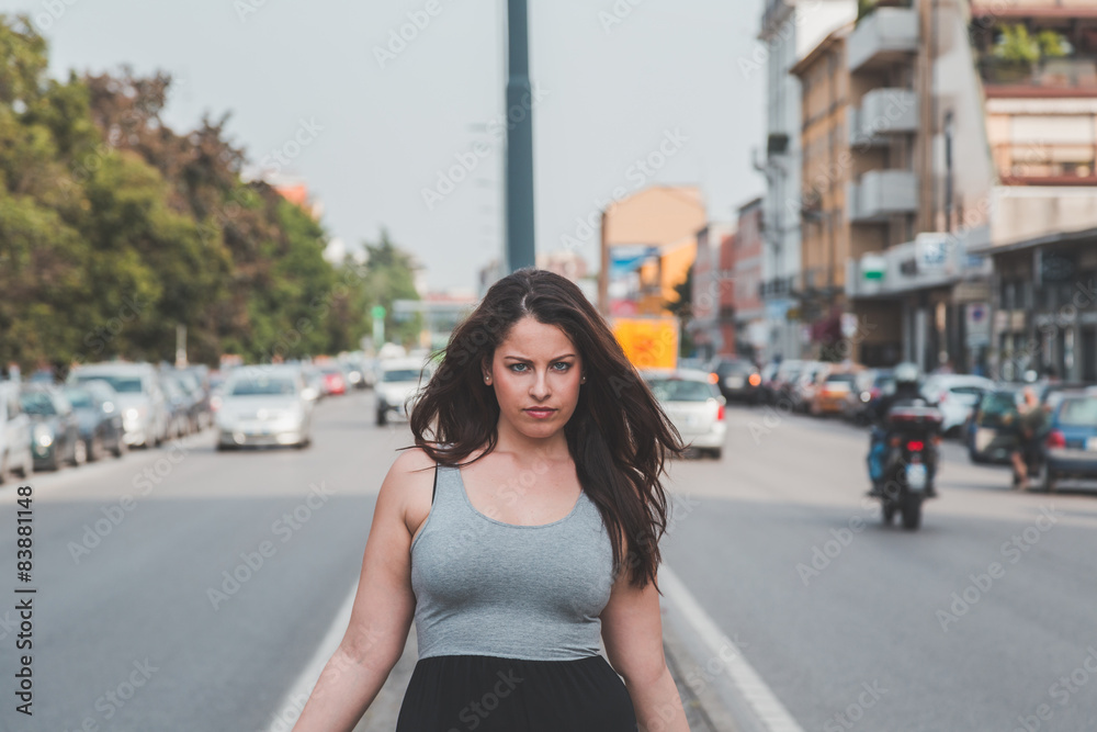 Beautiful curvy girl posing in an urban context