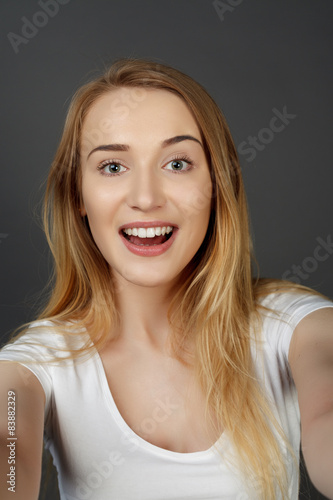 young pretty blonde women taking selfie on cell phone