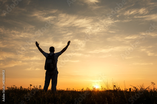 Silhouette of man with arms...