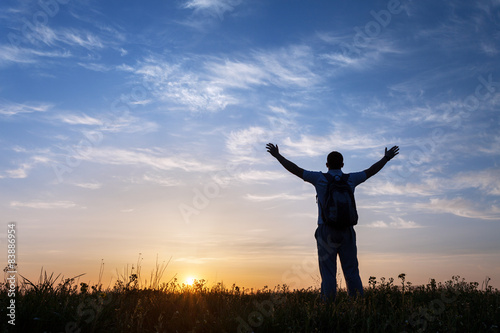 Silhouette of man with arms...