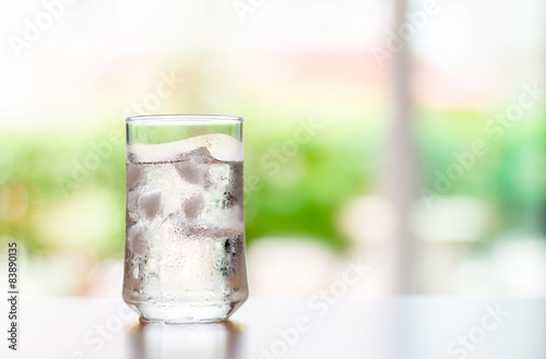 glass of Cool fresh drink with ice cube on the table