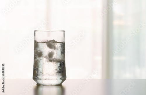 glass of Cool fresh drink with ice cube on the table