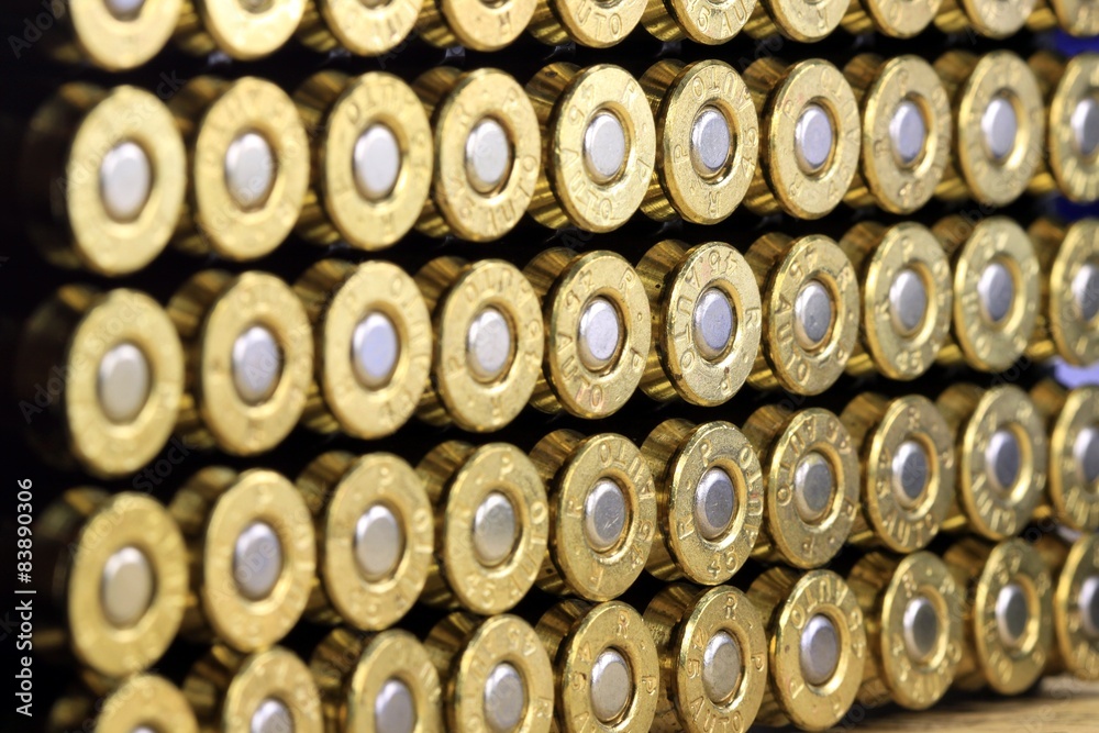A row of 45 caliber ammunition copper plated bullets A row of 45 caliber ammunition copper plated bullets