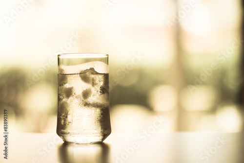 glass of Cool fresh drink with ice cube on the table