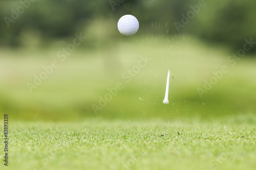 Golf ball just coming off the tee after hit by driver