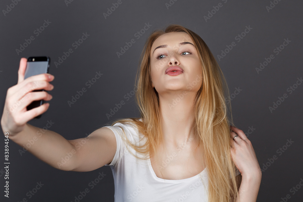 young pretty blonde women taking selfie on cell phone young pretty blonde women taking selfie on cell phone