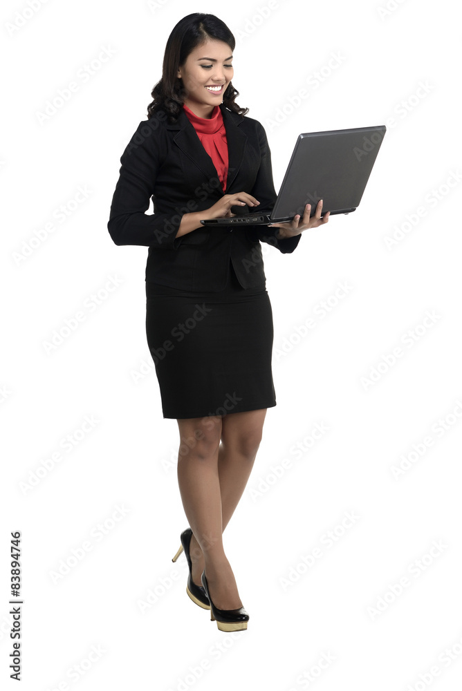 Asian business woman using laptop while standing Asian business woman using laptop while standing